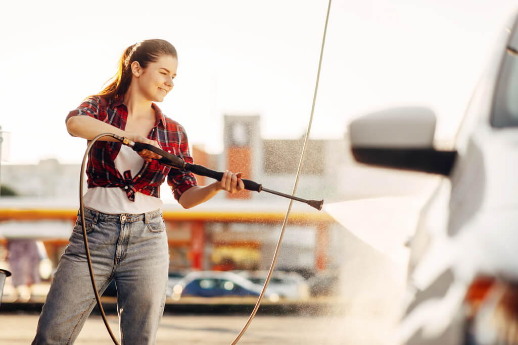 woman using the best pressure washer for your car